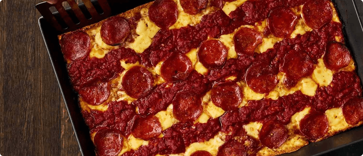 Freshly baked pizza in a delivery box