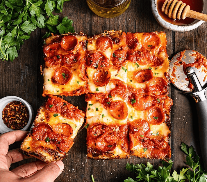 Square pepperoni pizza on wooden table